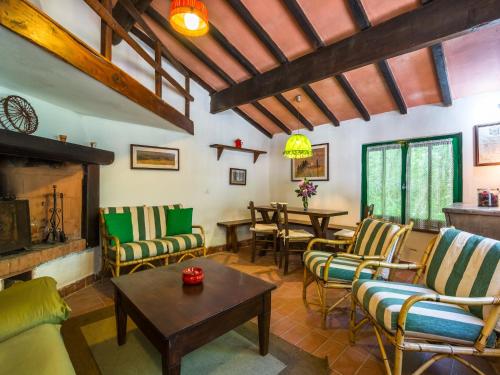 a living room with chairs and tables and a fireplace at Holiday Home with Garden and shared pool in Migliorini