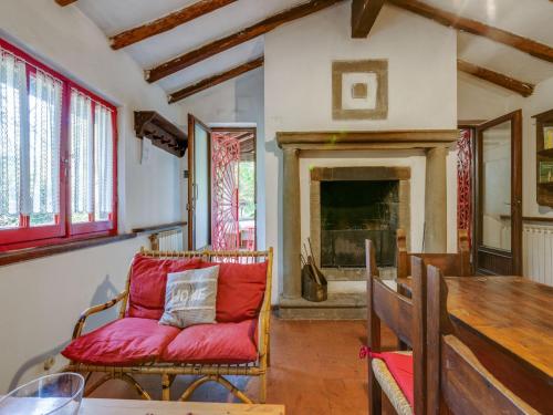 a living room with a red couch and a fireplace at Holiday Home with Garden and shared pool in Migliorini