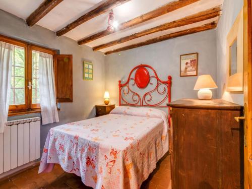 a bedroom with a bed with a red head board at Holiday Home with Garden and shared pool in Migliorini
