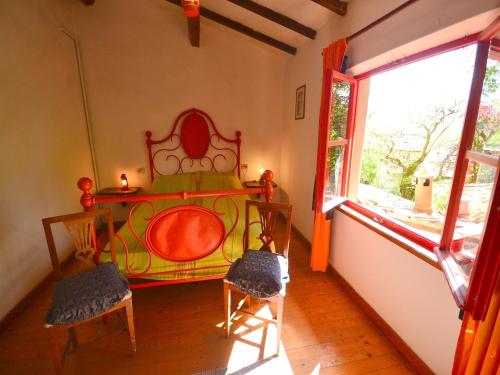 a bedroom with a bed and two chairs and a window at Holiday Home with Garden and shared pool in Migliorini