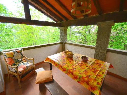 a screened in porch with a table and a chair at Holiday Home with Garden and shared pool in Migliorini