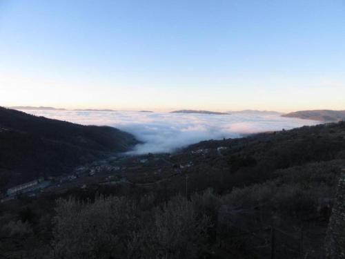 a view of a valley of clouds in the mountains at Holiday Home with Garden and shared pool in Migliorini