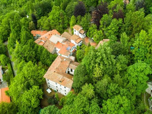 an aerial view of a house in the forest at Holiday Home with Garden and shared pool in Migliorini