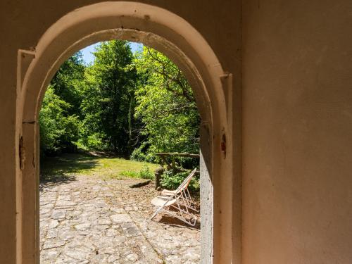 an archway leading into a garden from a house at Holiday Home with Garden and shared pool in Migliorini