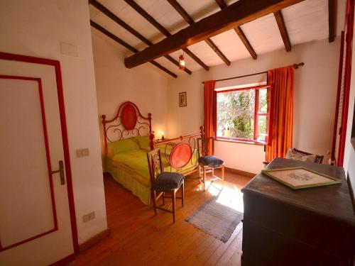 a bedroom with a bed and two chairs and a table at Holiday Home with Garden and shared pool in Migliorini