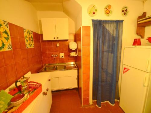 a small kitchen with a sink and a refrigerator at Holiday Home with Garden and shared pool in Migliorini