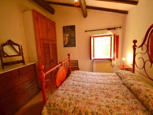 a bedroom with a bed and a dresser and a window at Holiday Home with Garden and shared pool in Migliorini