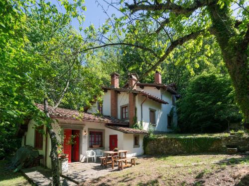 an old house with a picnic table in front of it at Holiday Home with Garden and shared pool in Migliorini
