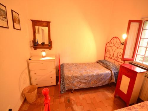 a bedroom with a bed and a dresser and a mirror at Holiday Home with Garden and shared pool in Migliorini