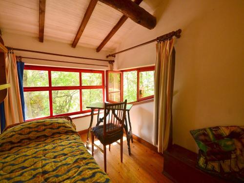 a bedroom with a bed and a table and a window at Holiday Home with Garden and shared pool in Migliorini