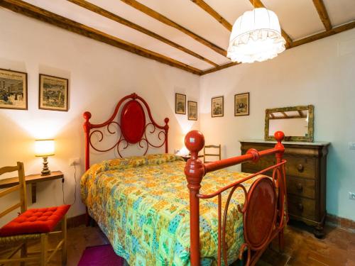 a bedroom with a bed and a table and a chair at Holiday Home with Garden and shared pool in Migliorini
