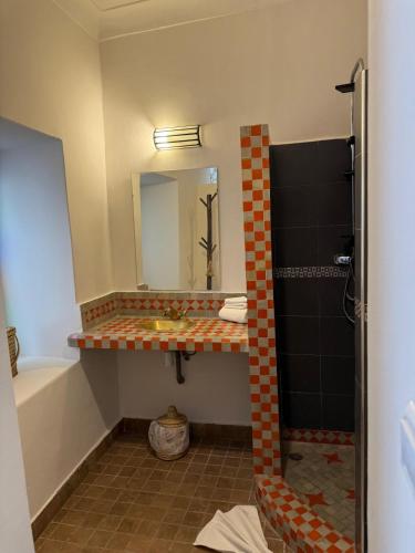 a bathroom with a sink and a mirror at Riad Dihya in Marrakech