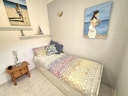 a small bedroom with a bed and a table at Casa Eladio - El Morche in Huit