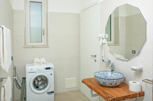 a bathroom with a washing machine and a sink at Vento Verde Apartments in Sperlonga