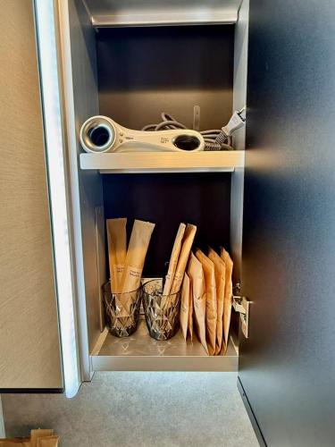 a refrigerator door is open with some food inside at Gouhou Garden Hotel Asakusa in Tokyo