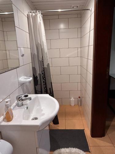 a bathroom with a sink and a shower at Casa da Maria in Prazeres