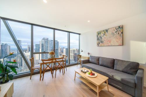a living room with a couch and a table at The Escape in Southern Cross Station in Melbourne