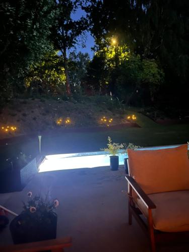 a patio at night with a bench and lights at Winding B&B Silkeborg in Silkeborg