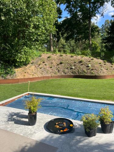 a swimming pool with a fire pit in a yard at Winding B&B Silkeborg in Silkeborg