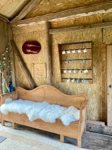 a bed in a room with a wall with wine glasses at Cabin in the Forest in Stillingsön