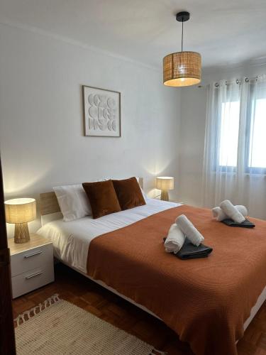 a bedroom with a large bed with two towels on it at Casa da Vila in Vila Franca do Campo