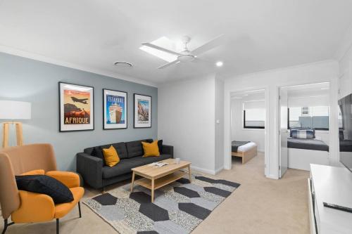 a living room with a couch and a table at Brigantine Escape - Harbourside Comfort near Beach in Shellharbour