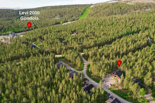 two hot air balloons flying over a forest at Villa Levi Snowlight, Modern & cozy cabin & 2 ski passes in Kittilä