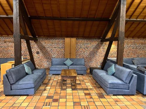 a living room with couches and a coffee table at Mansion with Pool, Néblon in Ouffet