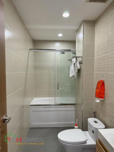 a bathroom with a shower and a toilet and a sink at TPHomes Lakeview 122 in Ho Chi Minh City