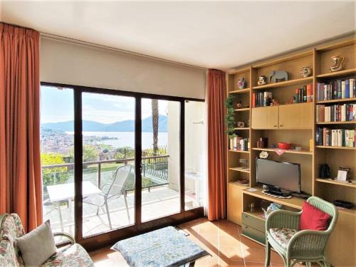 a living room with a large window and a balcony at Belvilla by OYO VC02 7 - Villa Castiglioni in Luino