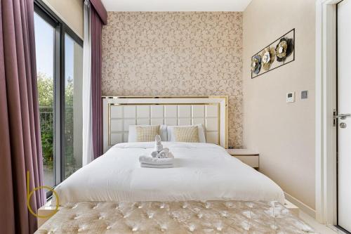 a bedroom with a bed and a large window at Bookable - 3 Bed Villa Damac Hills 2 in Dubai