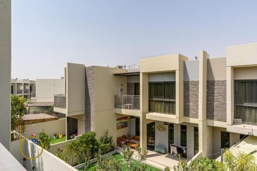 an image of an apartment building at Bookable - 3 Bed Villa Damac Hills 2 in Dubai