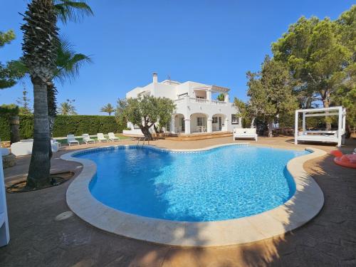 a swimming pool in front of a house at INIBIZA VILLAS - Villa Oasis in Sant Jordi