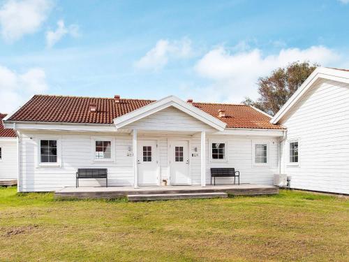 a white house with a large yard in front of it at Læsø Seaside Holiday Homes in Læsø