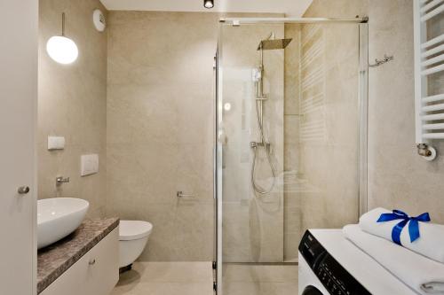 a bathroom with a shower and a sink at Casa Baia BlueApart Hel in Hel