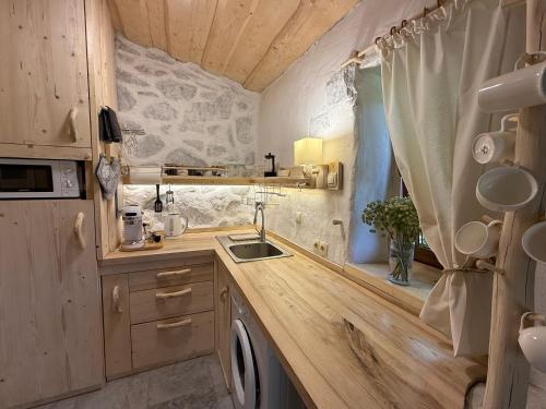 a tiny kitchen with a sink and a window at To Lem Ande in Lumshory