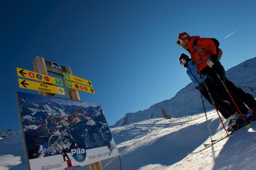 a person on skis standing on a snow covered mountain at Hotel Alla Posta in Saint Vincent