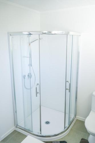 a shower with a glass enclosure in a bathroom at Richmond Heights apartment in Taupo