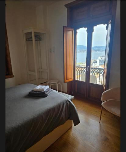 a bedroom with a bed and a window with a view at Casa Mama in Vigo
