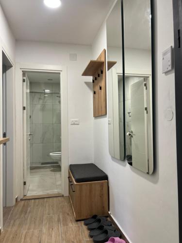 a bathroom with a toilet and a sink and a shower at LiboroApartments in Niš