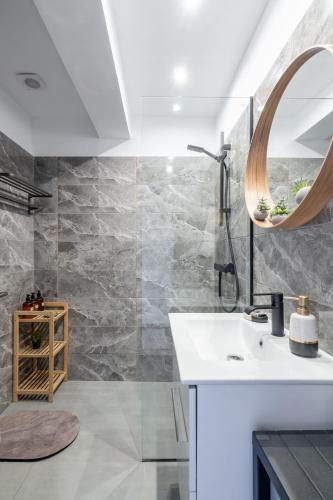 a bathroom with a sink and a mirror at Glyfada center seaview B in Athens