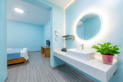 a bathroom with a sink and a mirror at wushe hotel in Dunhuang
