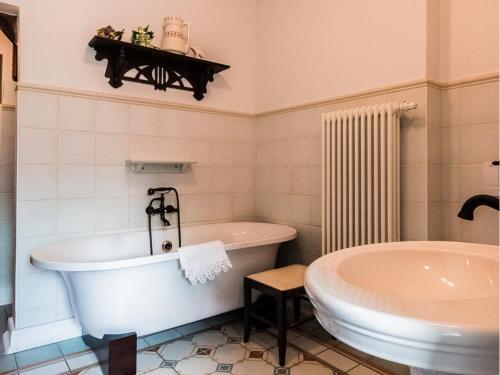 a bathroom with a bath tub and a sink at Timeless Charm in Gernrode in Gernrode - Harz