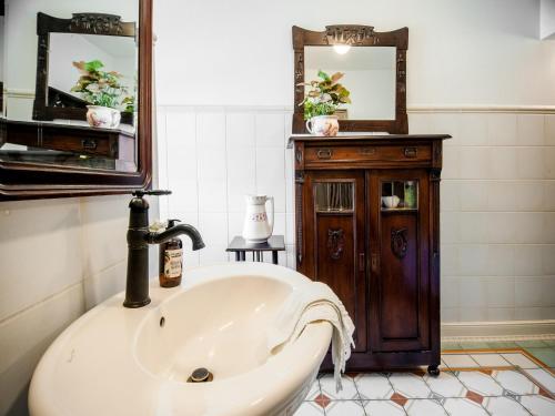 a bathroom with a sink and a mirror at Timeless Charm in Gernrode in Gernrode - Harz