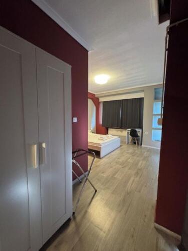 an empty room with a room with a couch and a table at Stay Hybrid Youth Hostel in Thessaloniki