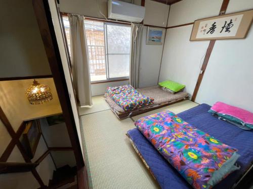 Letto o letti in una camera di AnNam Stay HOTARUGAIKE - - whole two story house rental