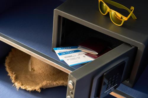 a safe with a pair of glasses on top of it at ibis Styles Katowice Airport in Pyrzowice