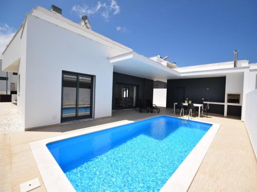 a swimming pool in the backyard of a house at Sunny Villa Near Óbidos w Beaches in Nadadouro