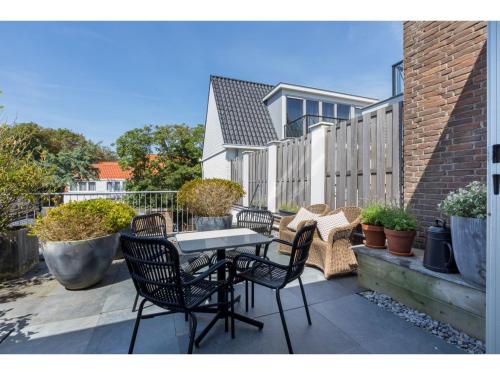 a patio with chairs and a table on a balcony at Central Domburg Apartment in Domburg