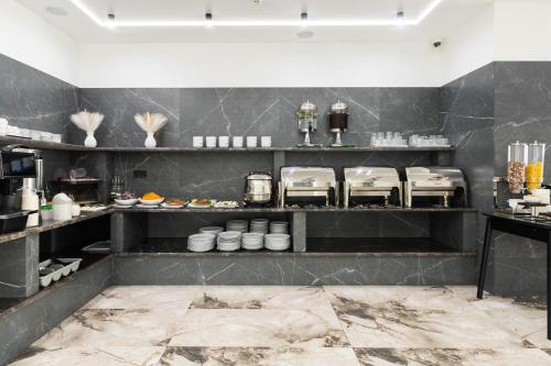 a kitchen with black walls and shelves with food at Villa Nikoletta SPA in Bukovel